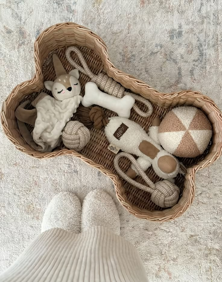 Wicker bone-shaped basket filled with plush toys
